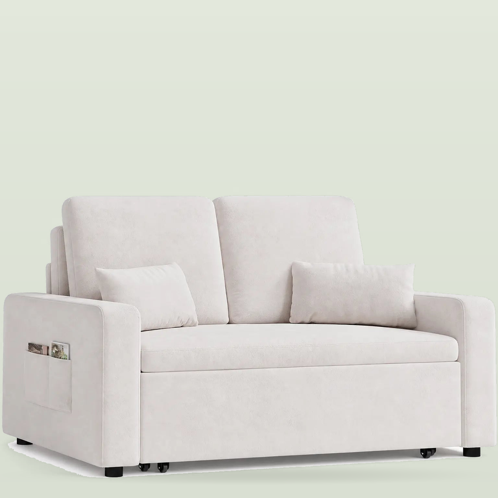 Two-seat sofa bed in pale beige fabric with two back cushions, two small cushions and a pocket in the left arm, on a pale sage background