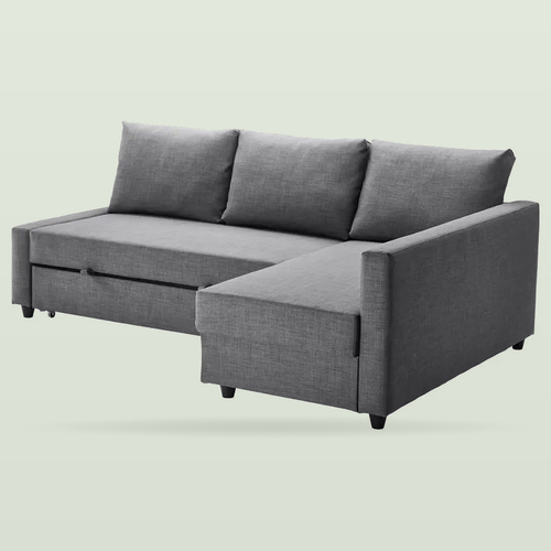Dark grey corner sofa bed with a chaise longue on the right and three back cushions, on a pale sage background