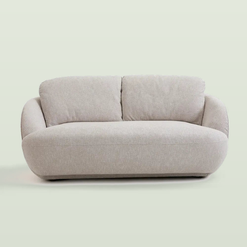 Low bench sofa in heathered greige cotton with two loose back cushions and rounded arms, front view on a pale sage background