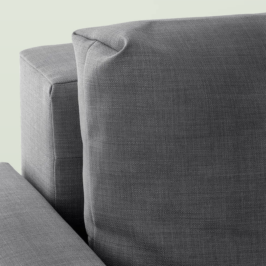 Close-up of the dark grey woven cover on a back cushion and the arm