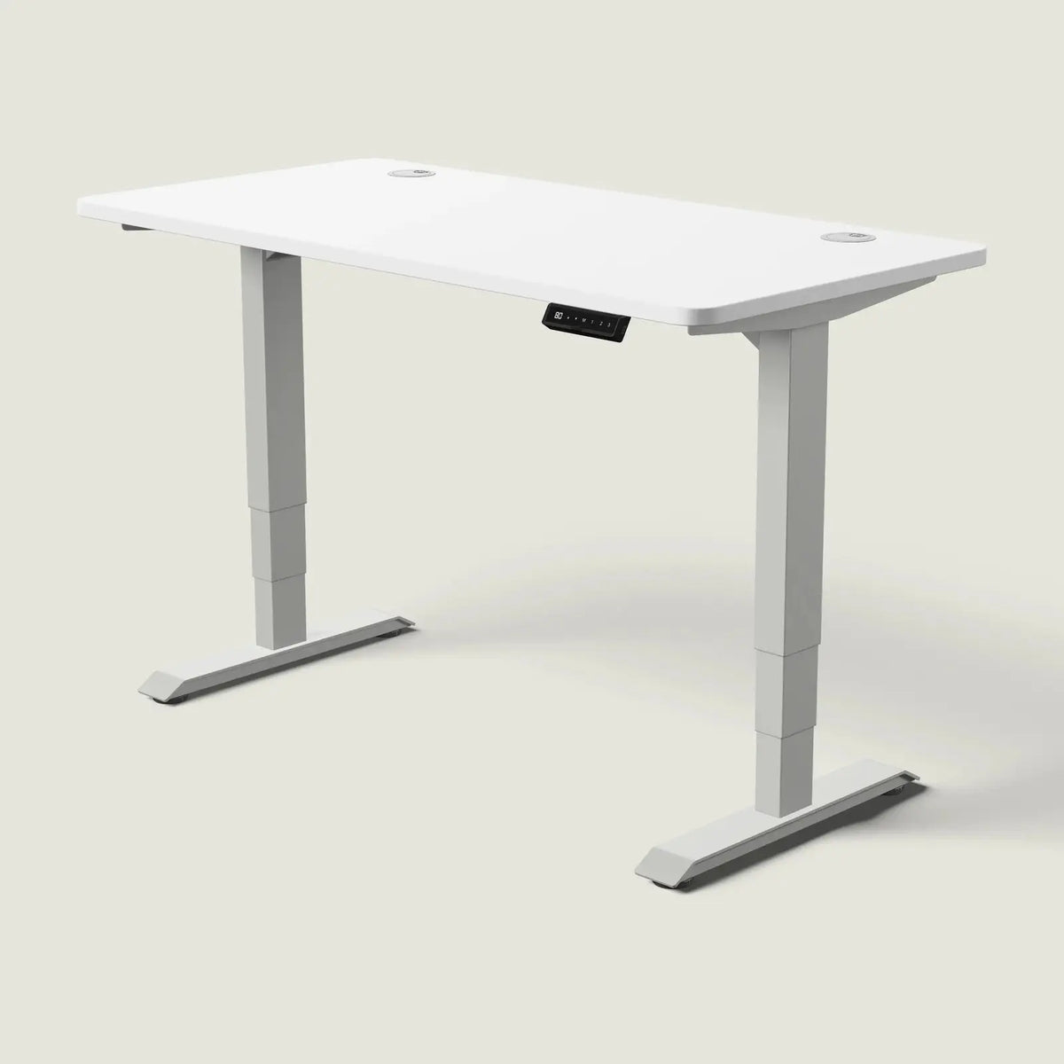 Electric standing desk, 140 × 70 cm, grey frame and white top, with the memory handset under the front edge, on a pale grey background
