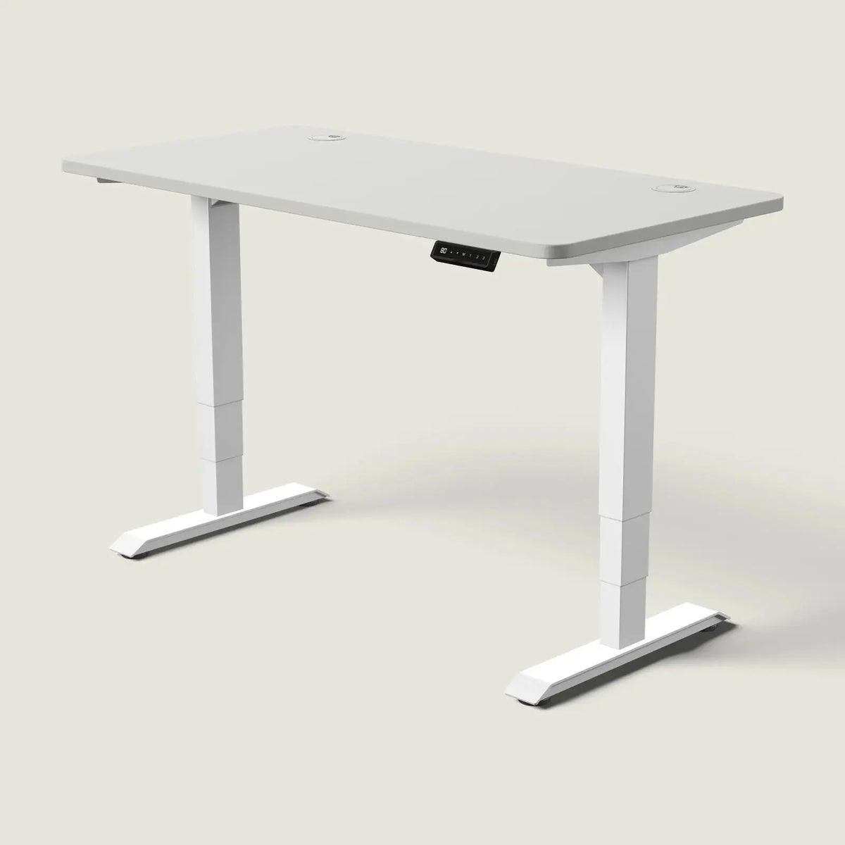 Electric standing desk, 140 × 70 cm, white frame and grey top, with the memory handset under the front edge, on a pale grey background