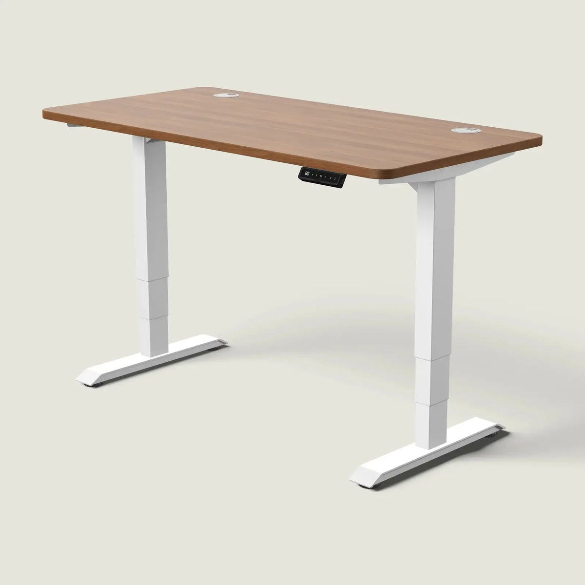 Electric standing desk, 140 × 70 cm, white frame and walnut-effect top, with the memory handset under the front edge, on a pale grey background